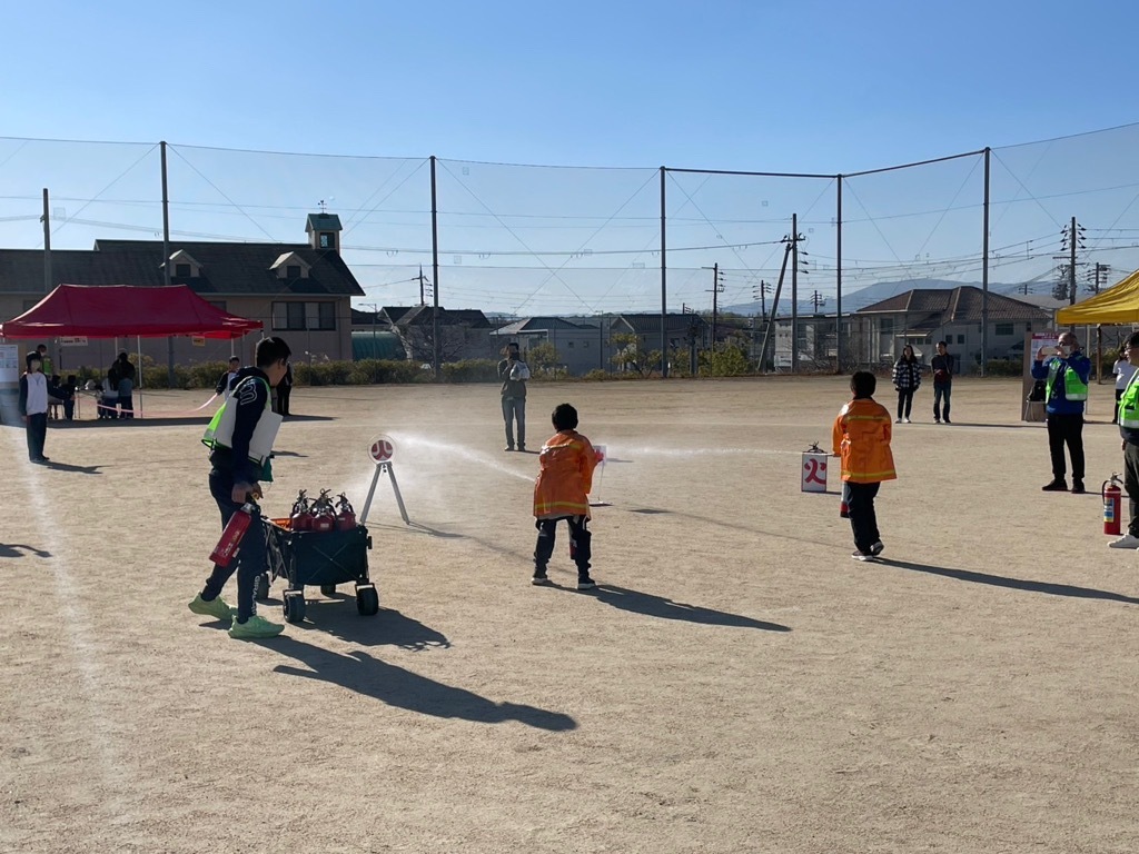 消火訓練中の子供たちの写真