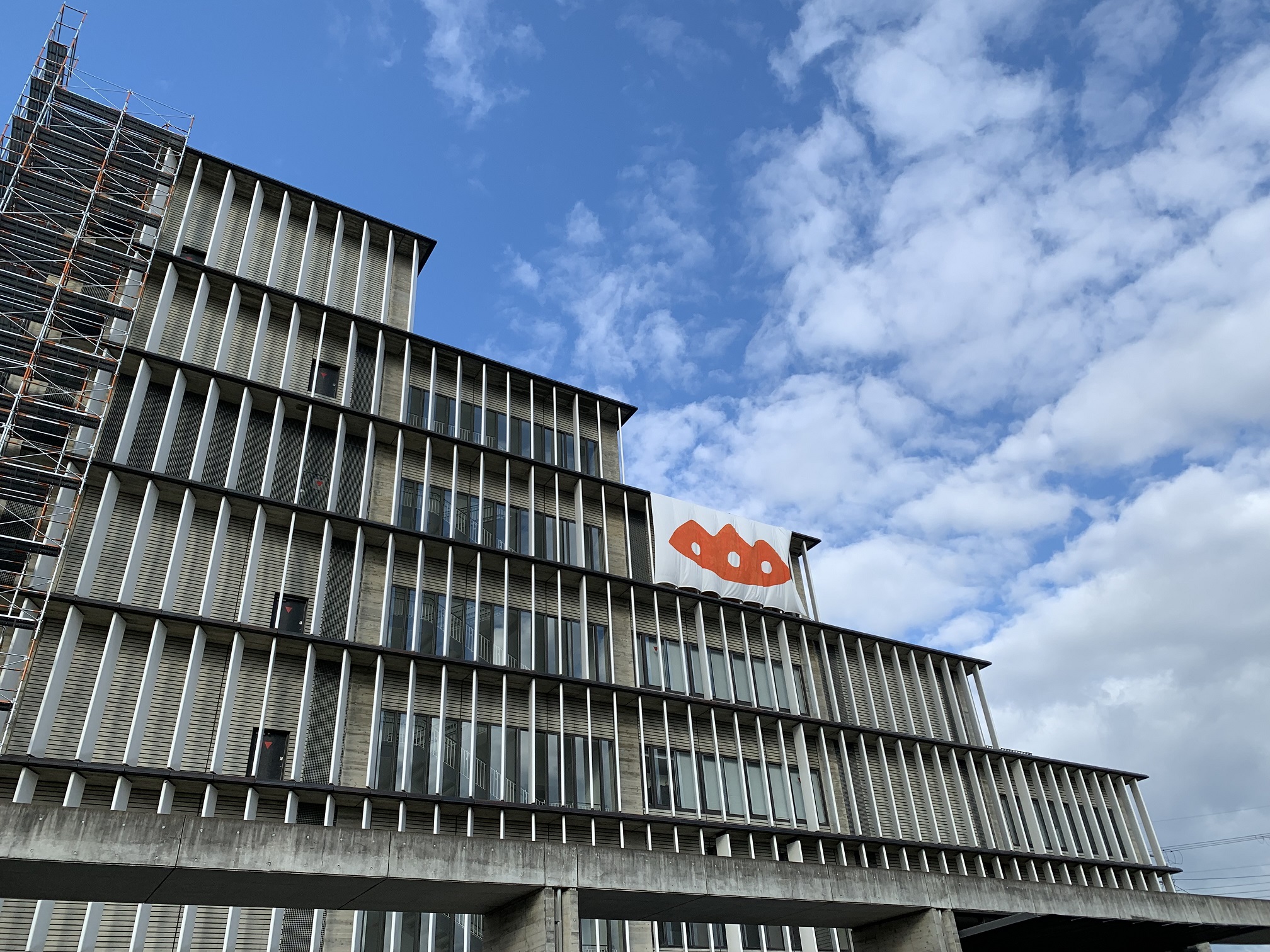 市役所本庁東側外壁5階部分に掲示された木津川アート巨大シンボルマークの横断幕の写真